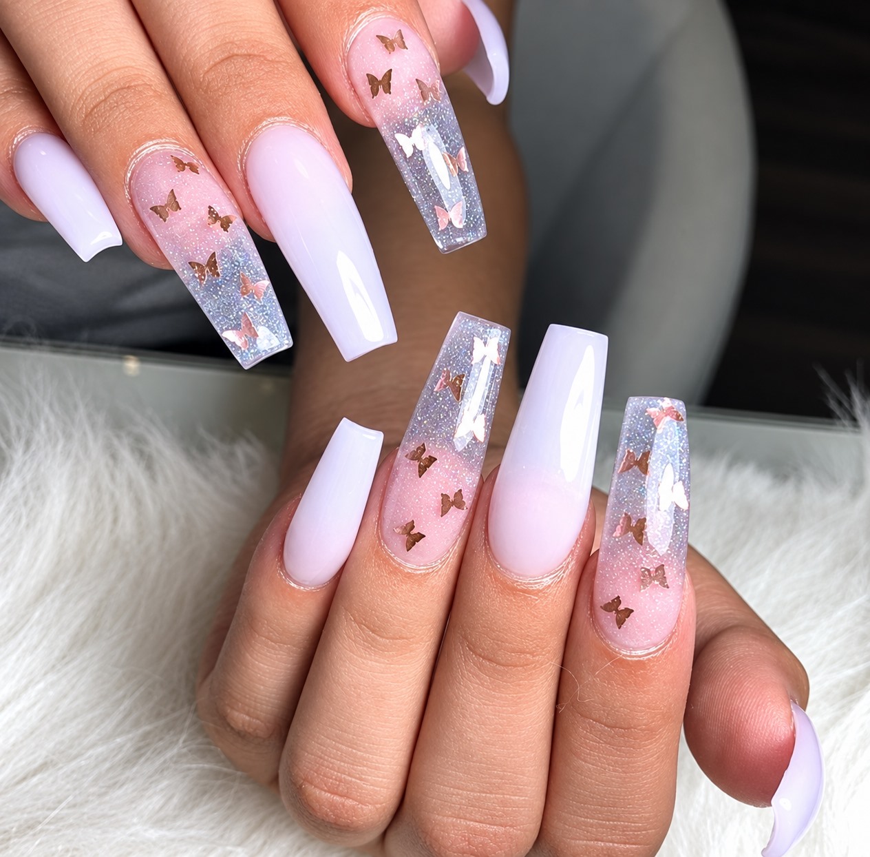 Pink and lilac nails with butterfly accents from Jessica Nails & Spa