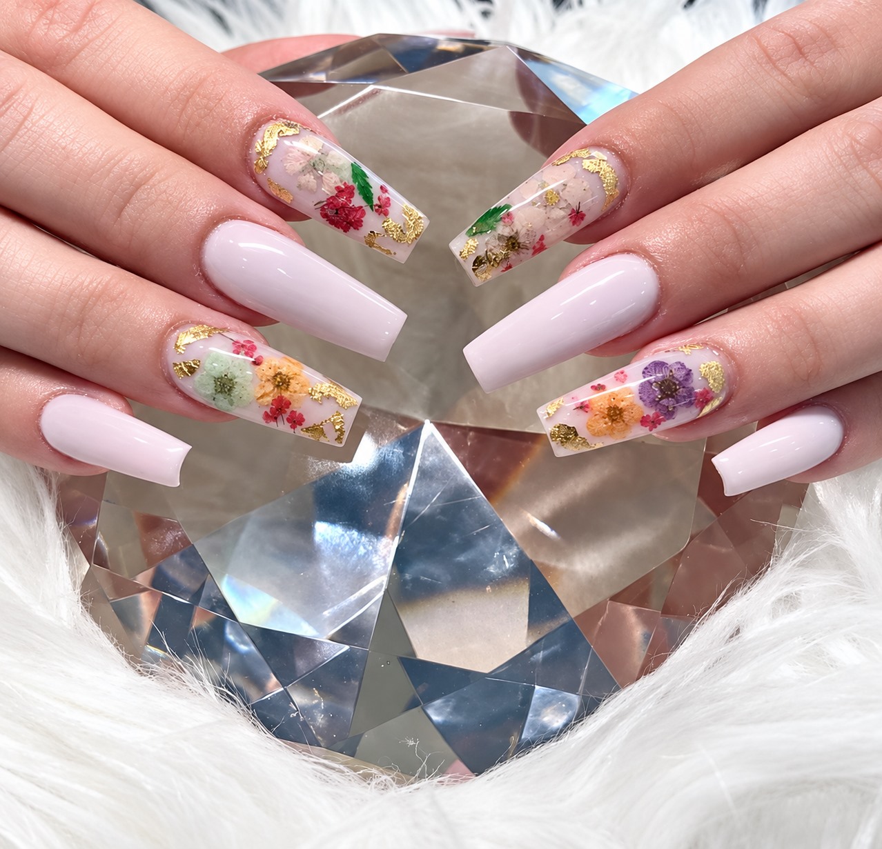 White nails with floral and gold accents, photographed at Jessica Nails & Spa